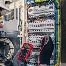 man-electrical-technician-working-switchboard-with-fuses