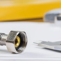 All kinds of plumbing and tools on sheet of paper